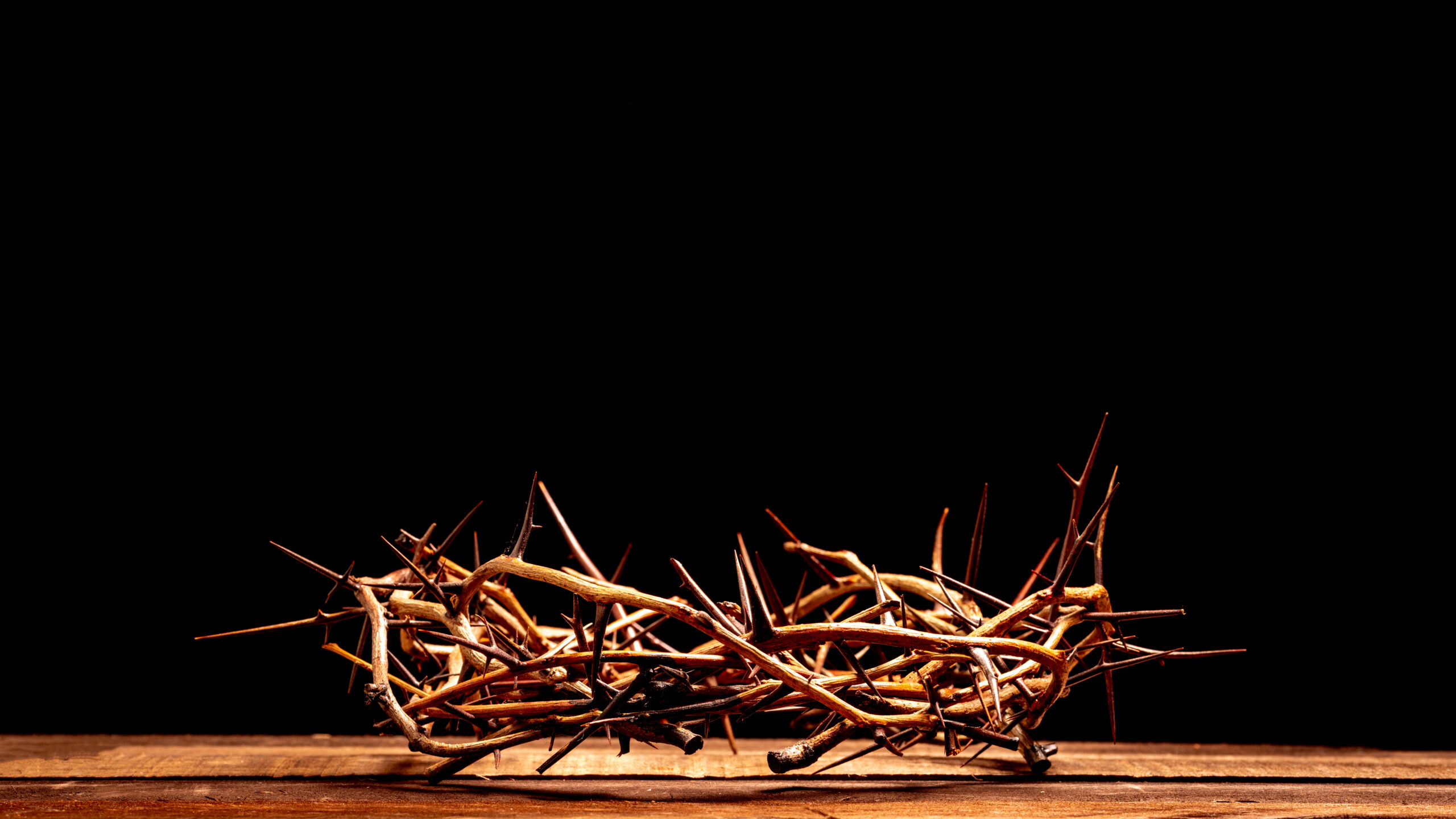 An authentic crown of thorns on a wooden background. Easter Theme
